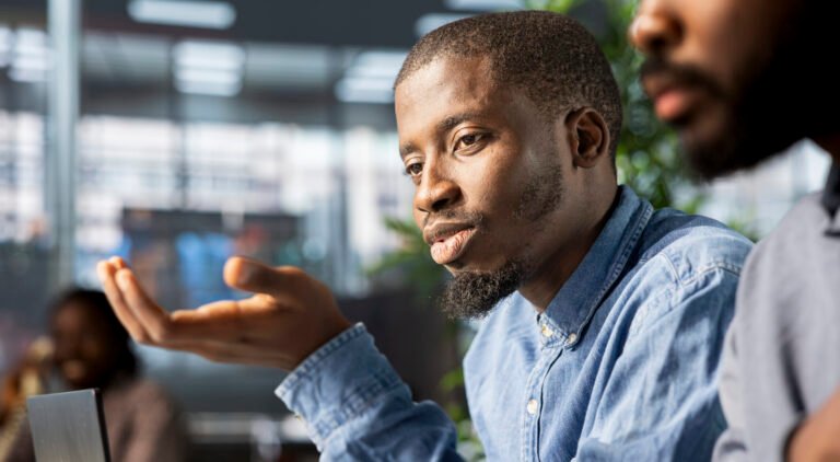 African american corporate team focuses on data management, planning strategies for company growth and aligning business goals with performance metrics for measurable success.